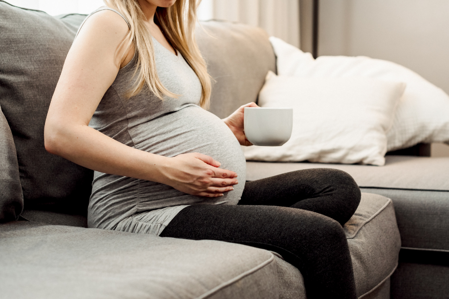 Pregnant woman drinking coffee