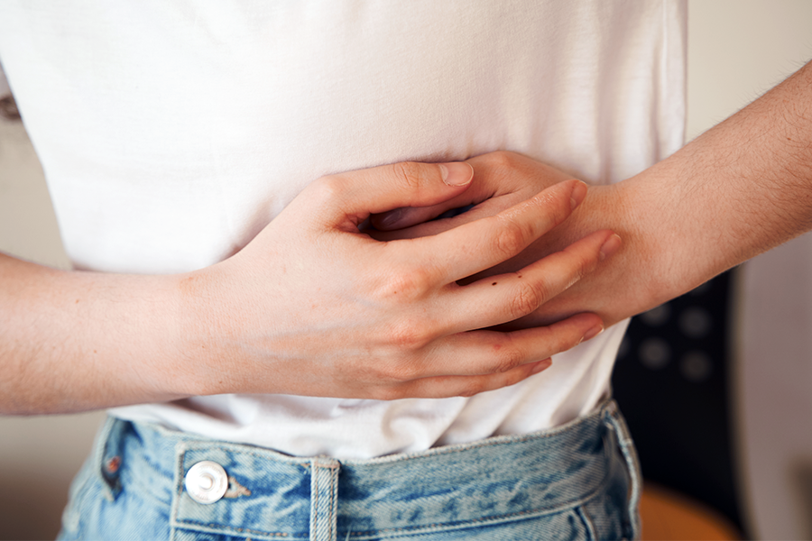 Can endometriosis have no symptoms? Patient holds side in pain, but most common symptom is infertility.